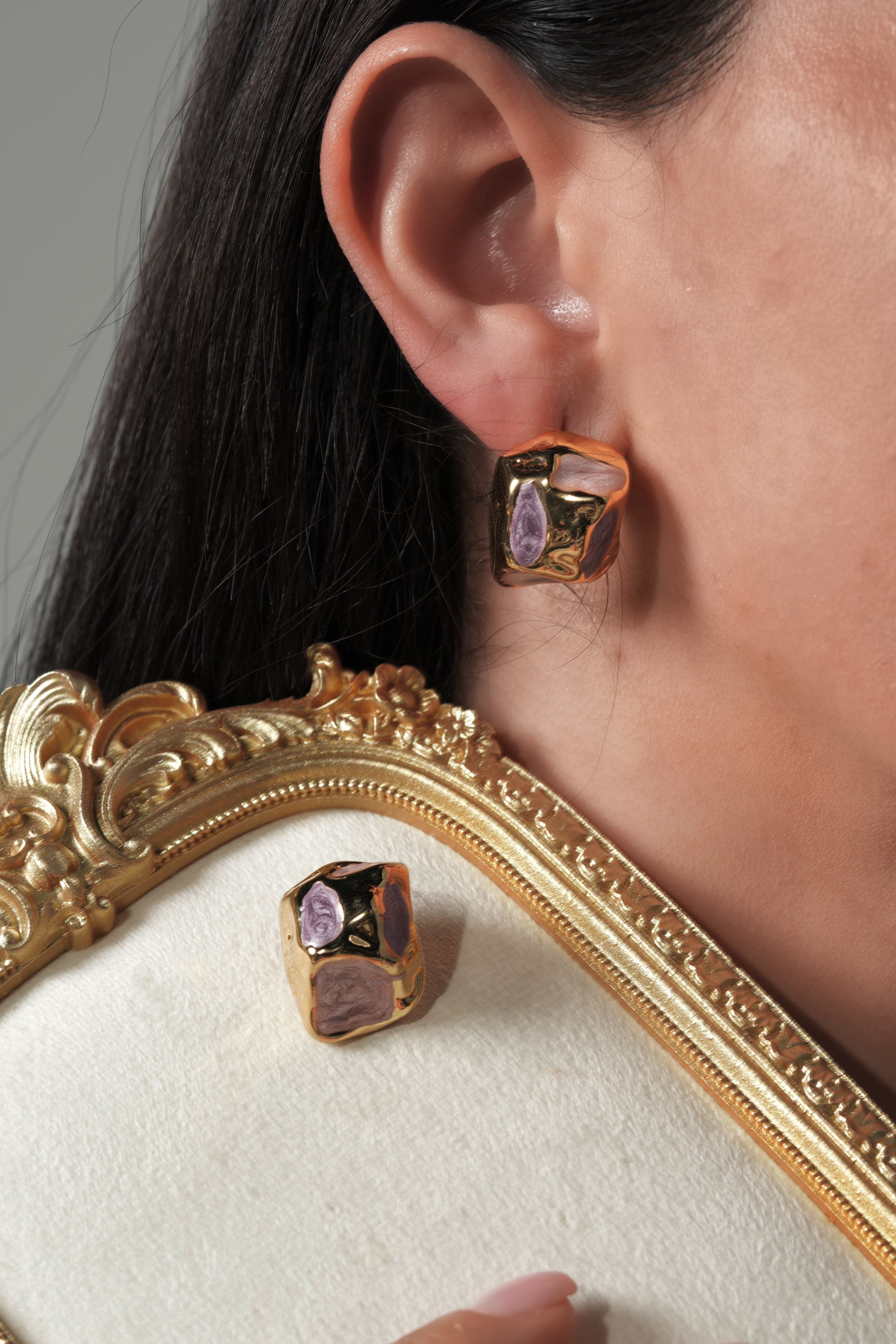 Golden rock with purple earrings
