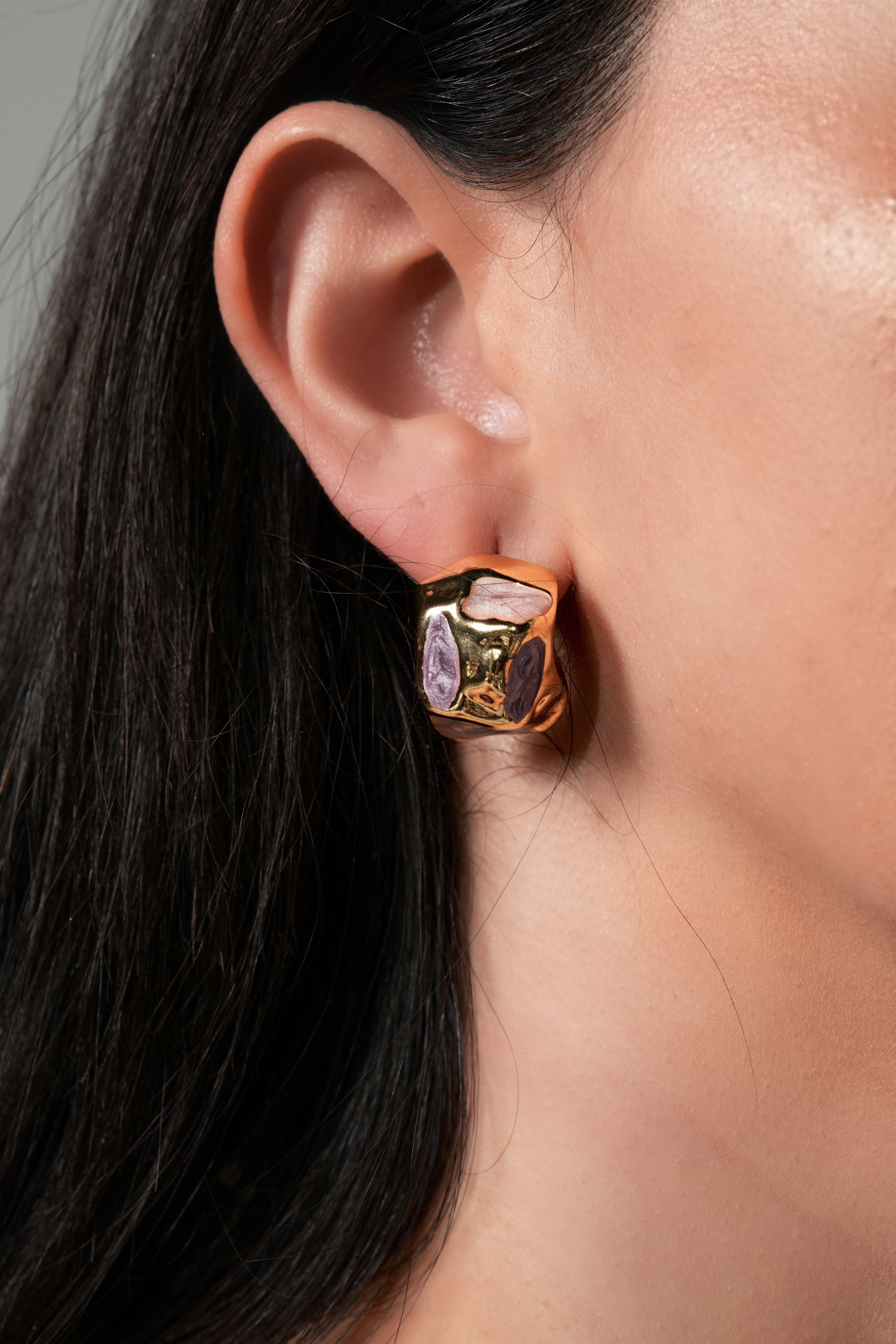 Golden rock with purple earrings